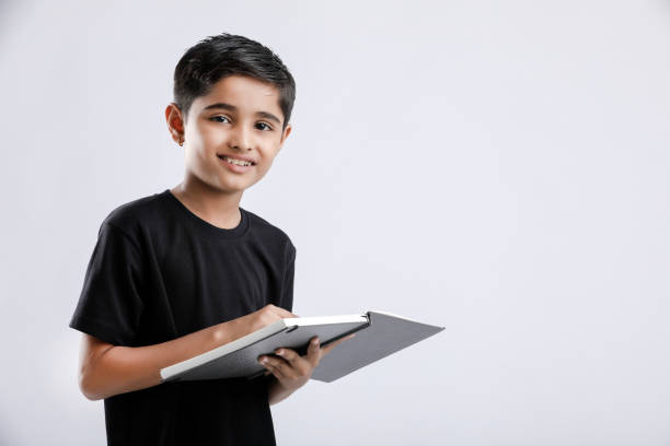 little Indian / Asian boy with book on head